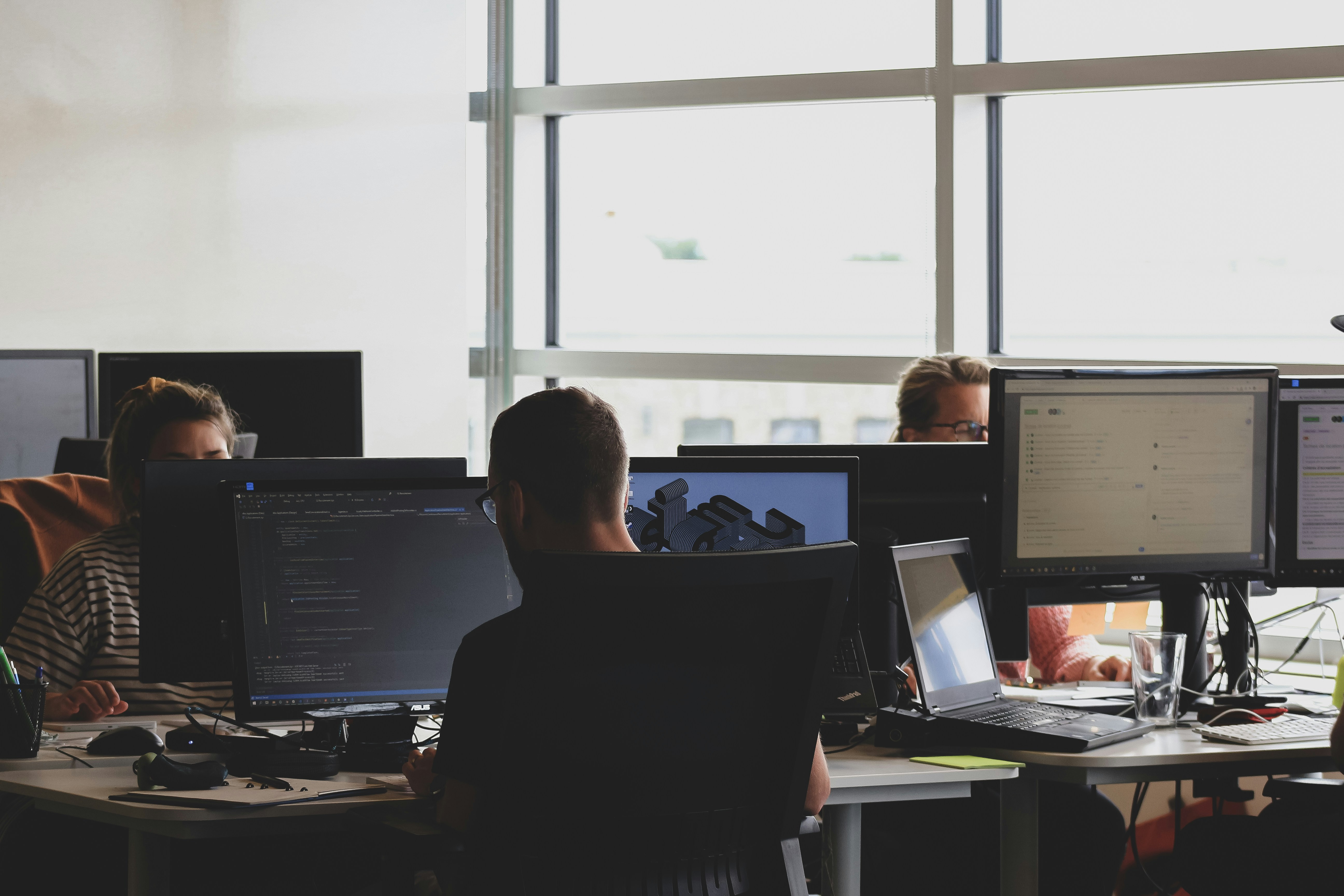 A cybersecurity team reviewing dashboards in a security operations workspace